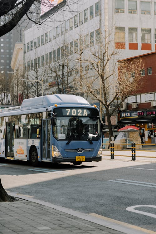 A bus is driving down a street in a city