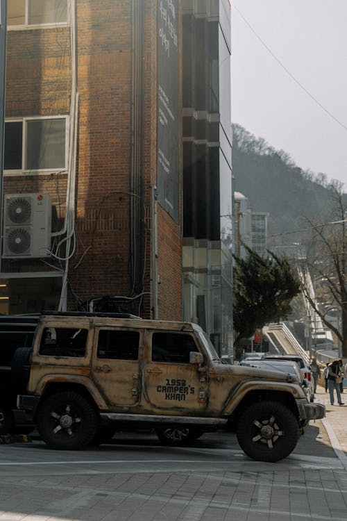 A jeep parked on the side of the road with a building in the background