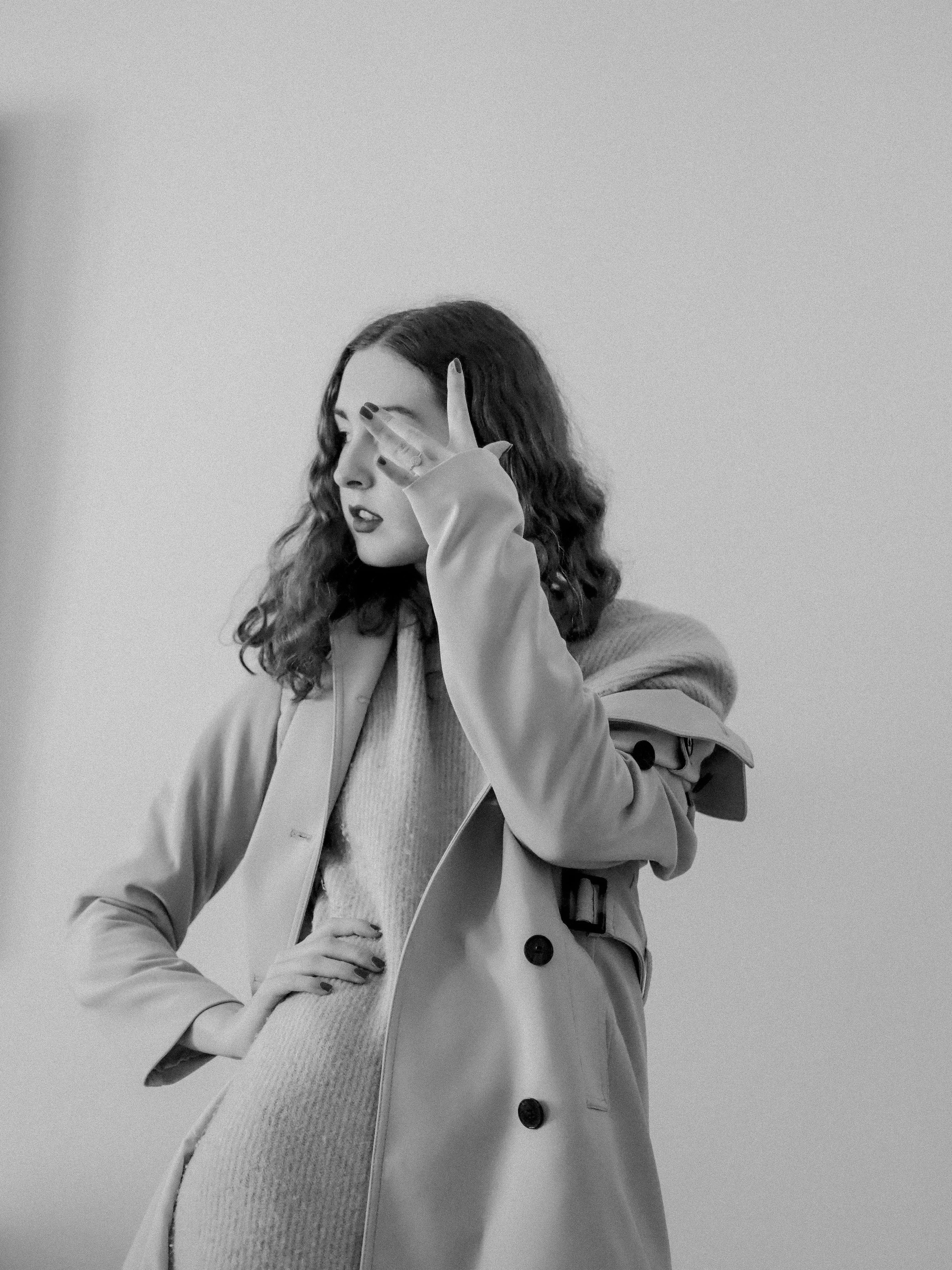 Chic grayscale portrait of a woman in a stylish coat in Paris.
