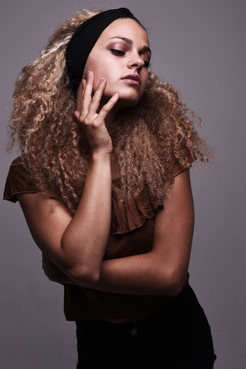 A woman with curly hair posing for a portrait