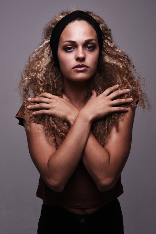 A woman with curly hair posing for a portrait