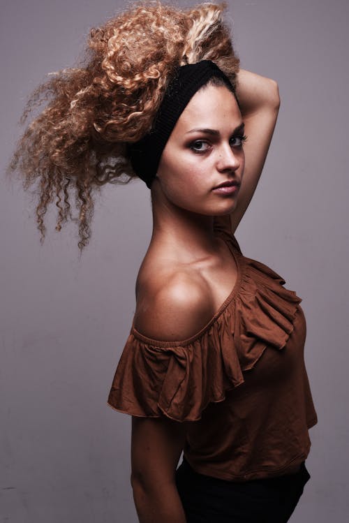 A woman with curly hair posing for a photo