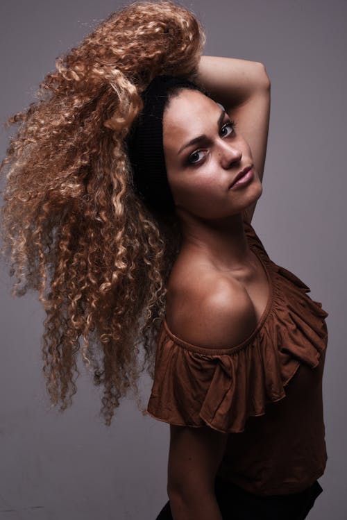 A woman with curly hair posing for a photo