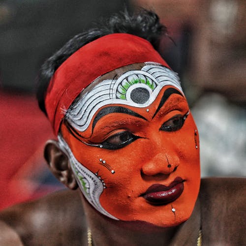 A man with painted face and red eyes