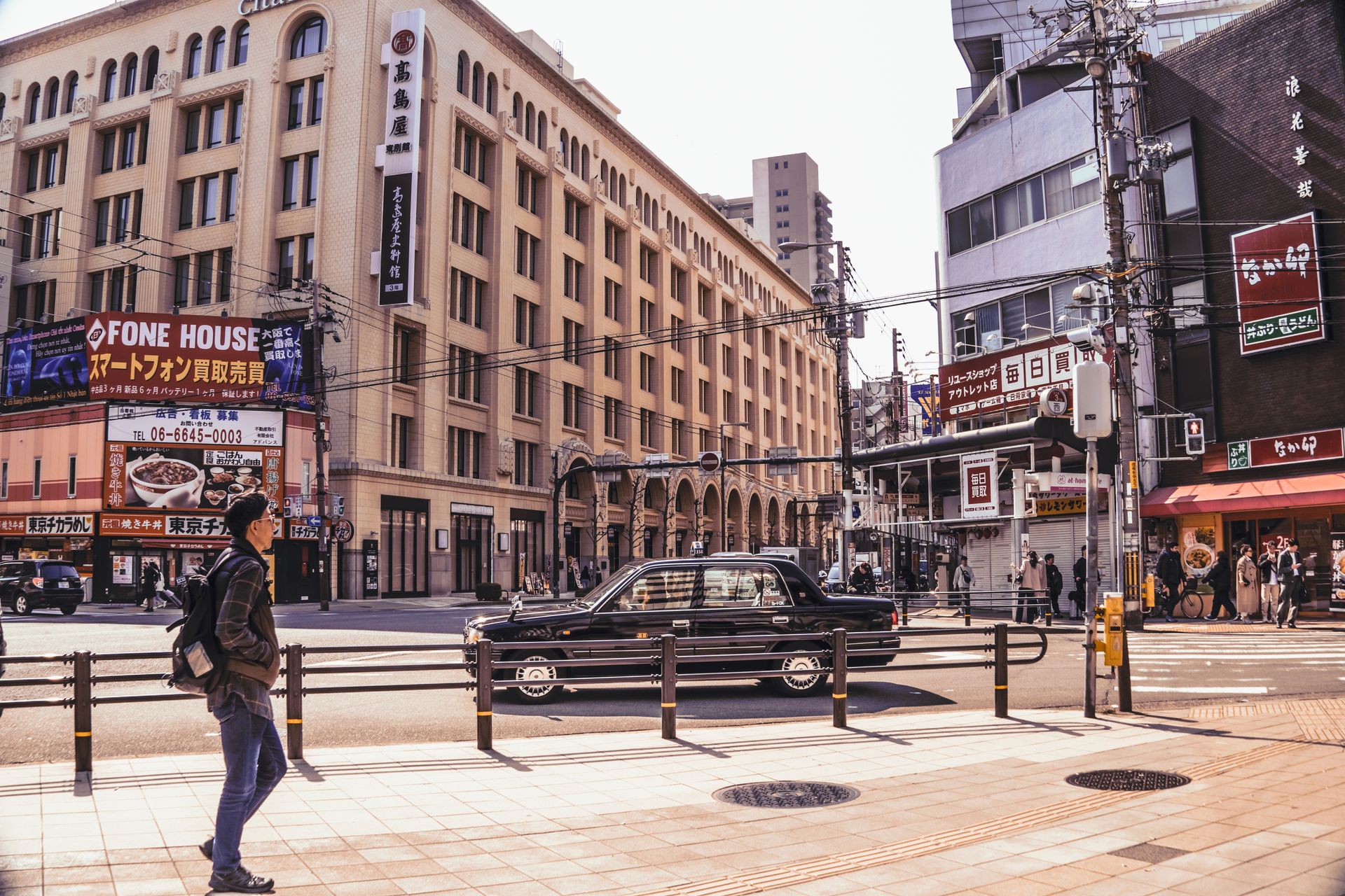 Bustling Tokyo street with classic buildings and lively urban atmosphere.