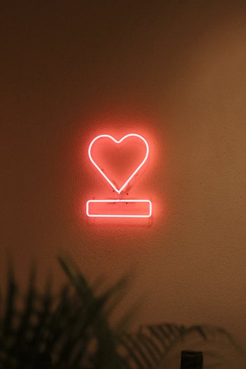 A neon sign with a heart on it