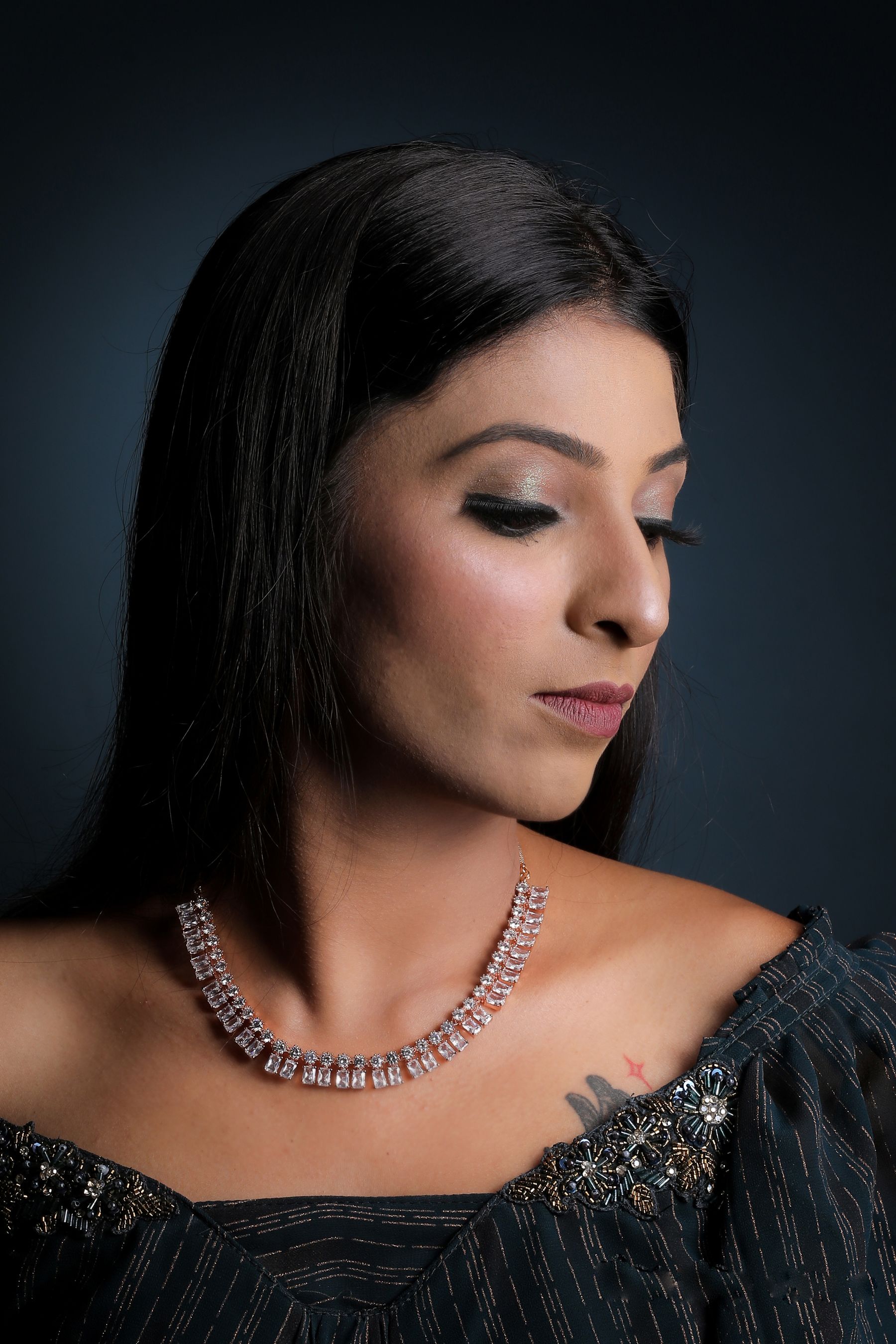 Portrait of a woman wearing a diamond rivière necklace