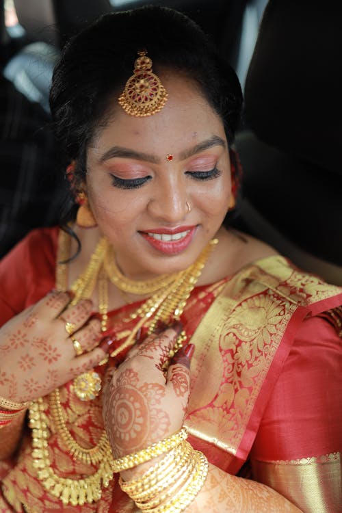A woman in traditional indian attire with gold jewelry