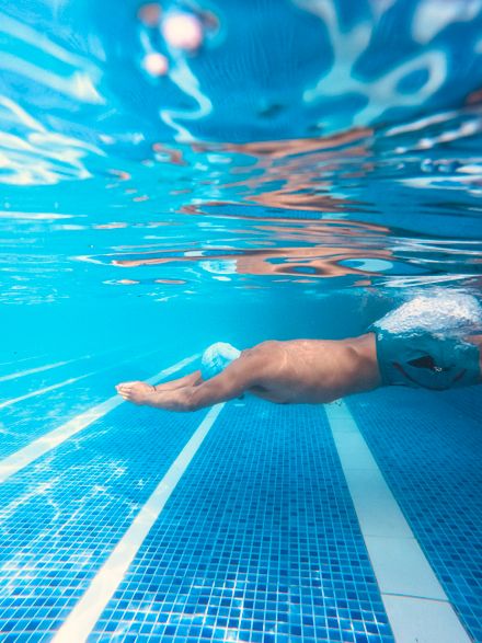 Swimmer moving underwater in a clear blue pool — photo by Prabin Sunar on Pexels
