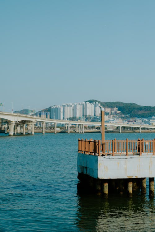 A pier with a bridge in the background