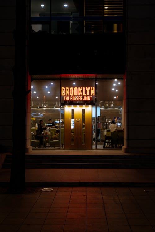 A restaurant with a neon sign that says brooklyn