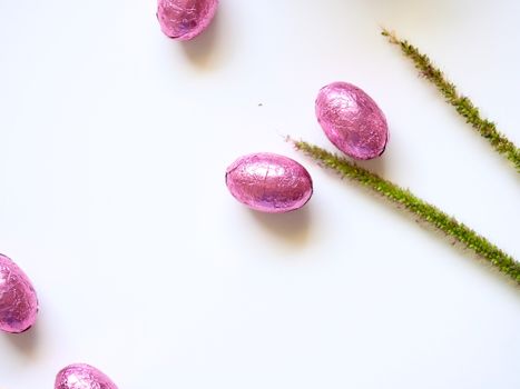 delicious sweets near green delicate stems on white table