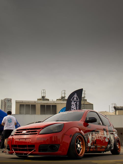 A red car with a big wheel on it