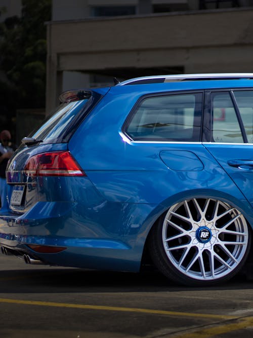 A blue volkswagen golf wagon parked in a parking lot