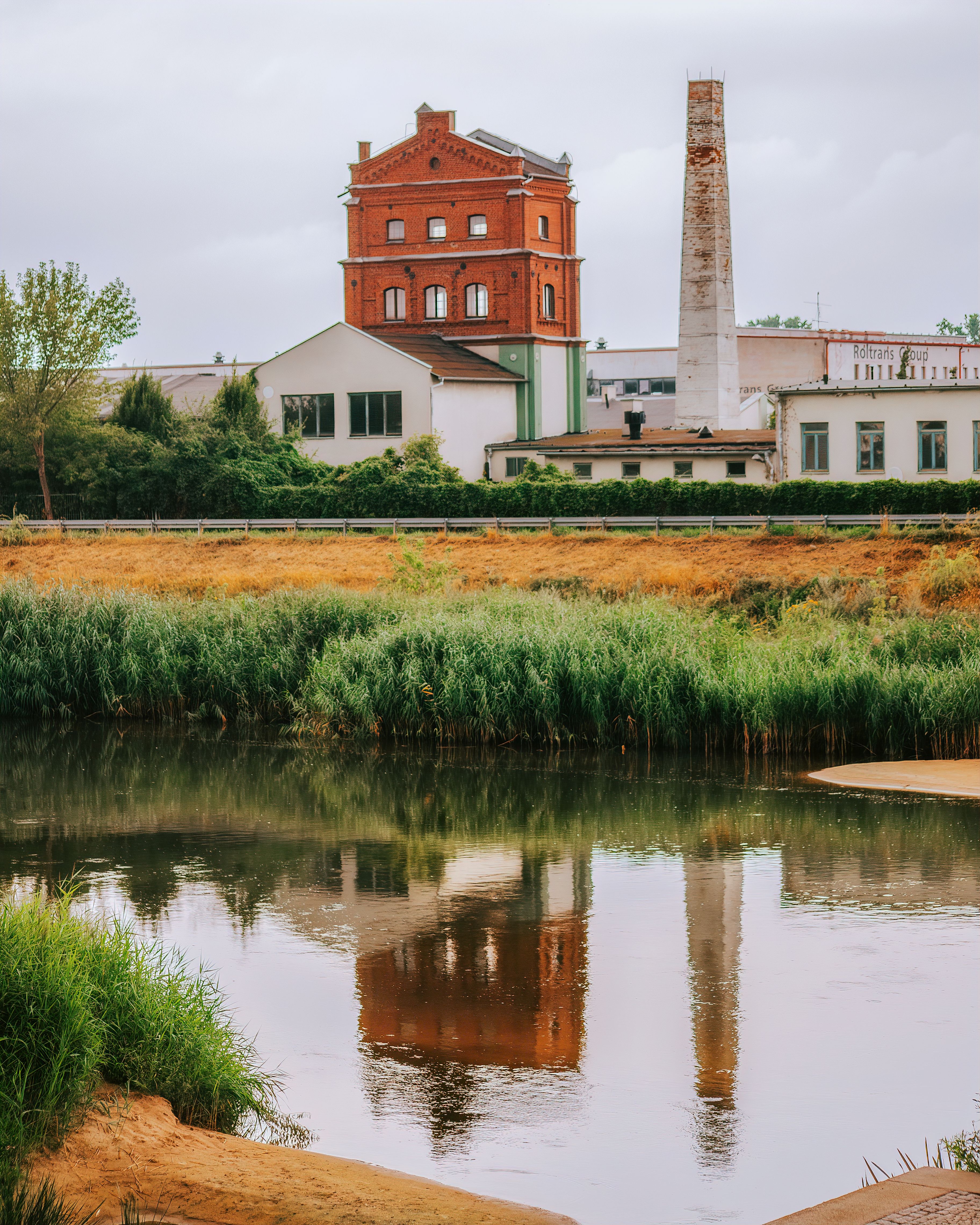 A photo of a factory and a river · Free Stock Photo