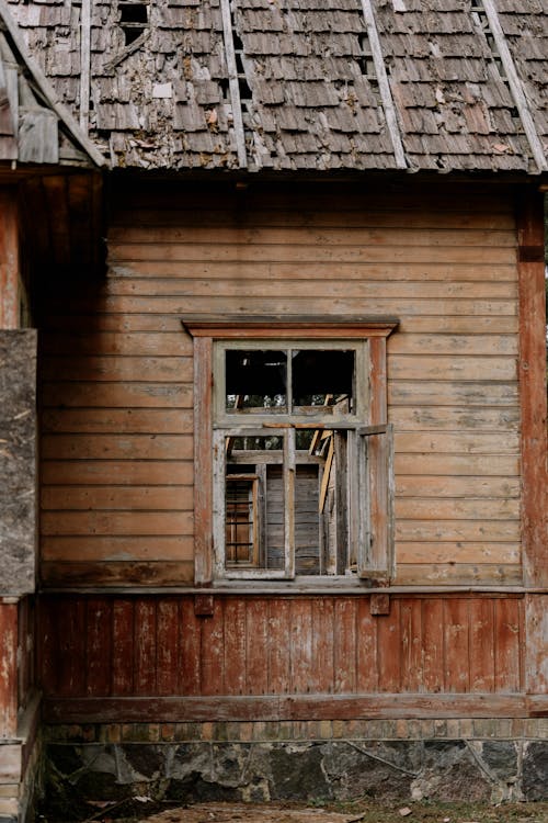An old wooden house with a broken window