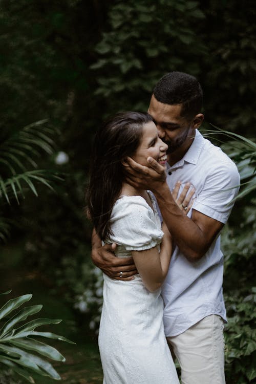 A couple embracing in the jungle during their engagement session