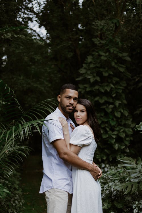 A couple embracing in the jungle during their engagement session