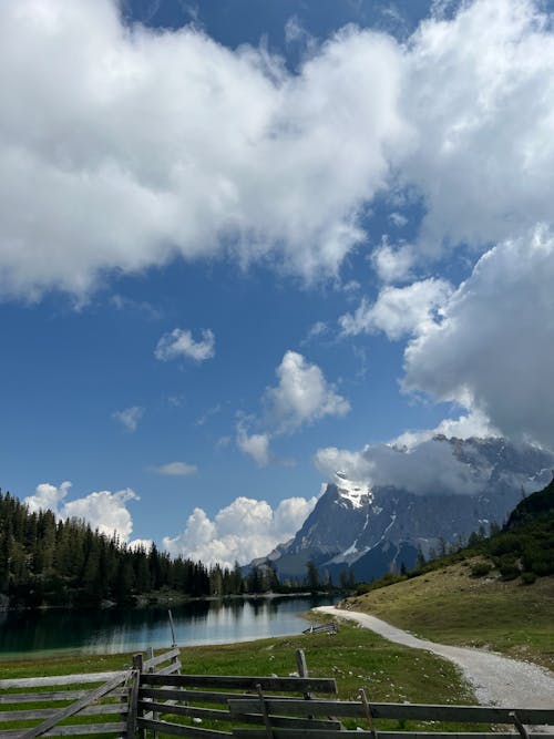 A lake and mountains in the background with a fence