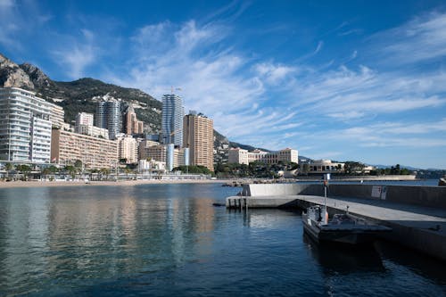 A boat docked in front of a city skyline