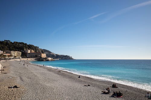 A beach with people on it and a blue sky