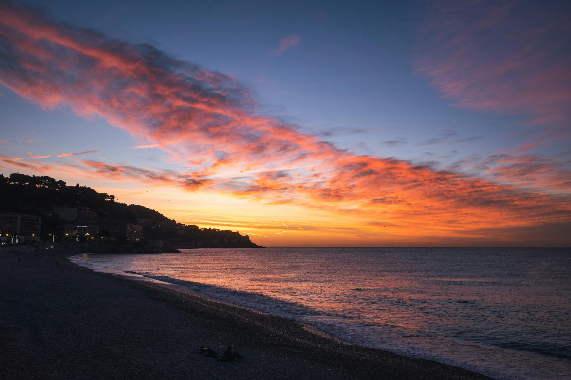 A sunset over the ocean and beach
