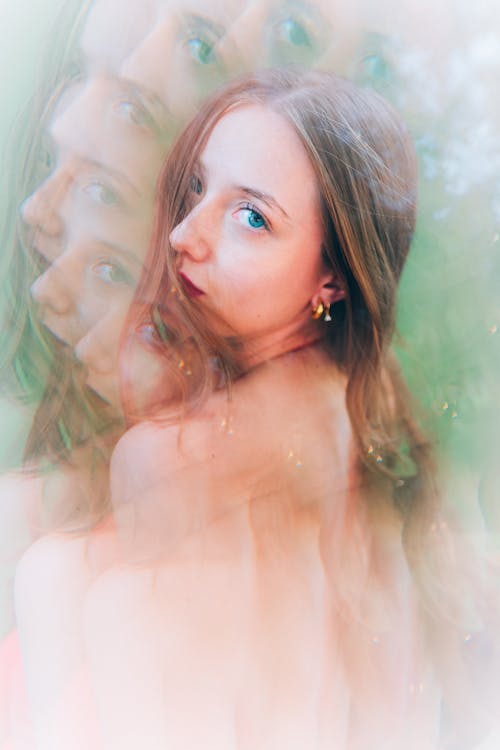 A woman with long hair and a green background