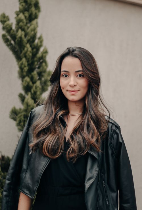 Photo of a Smiling Young Woman Wearing a Leather Jacket · Free Stock Photo