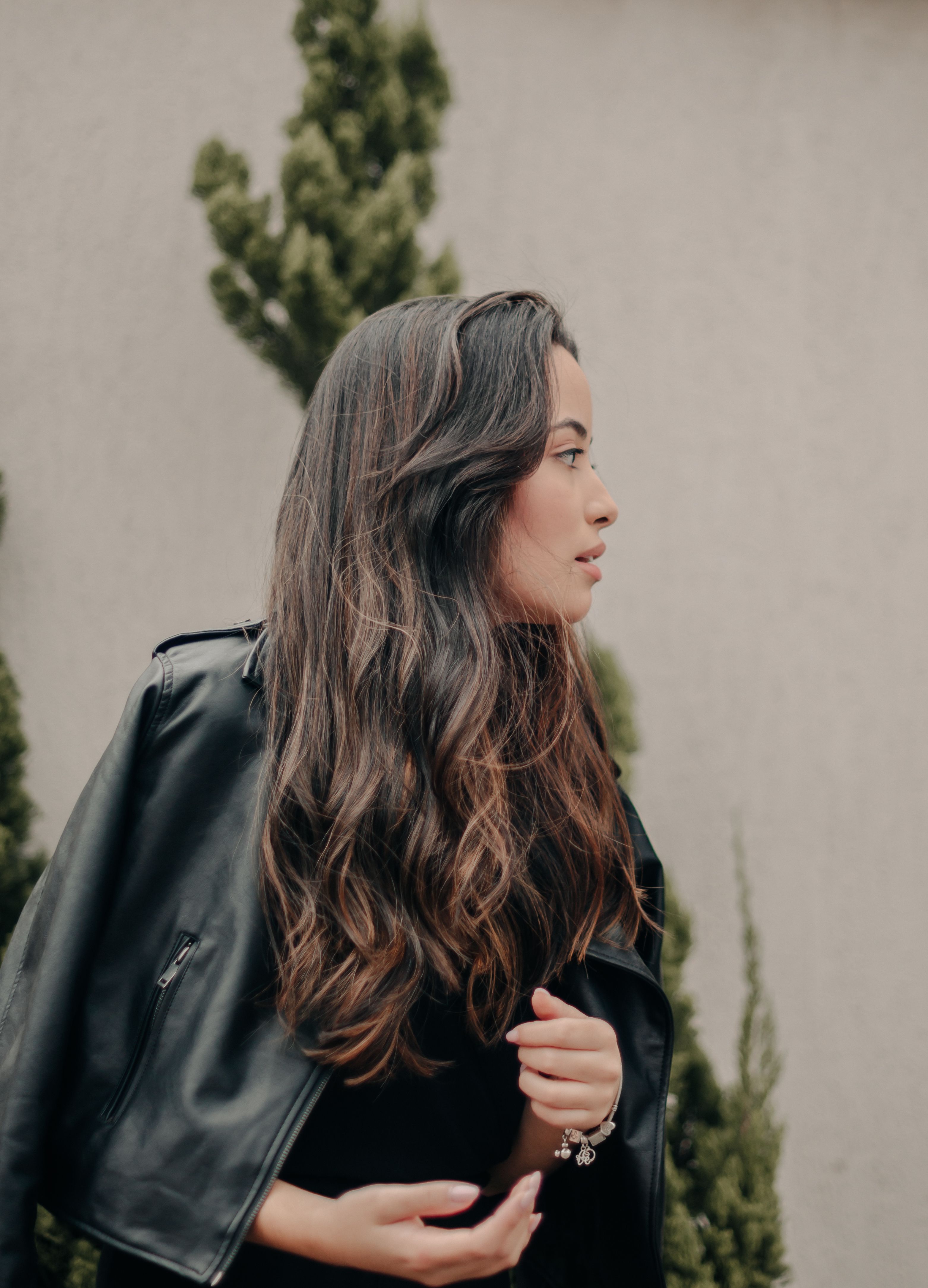 Photo of a Young Brunette in a Leather Jacket Standing Outside · Free ...