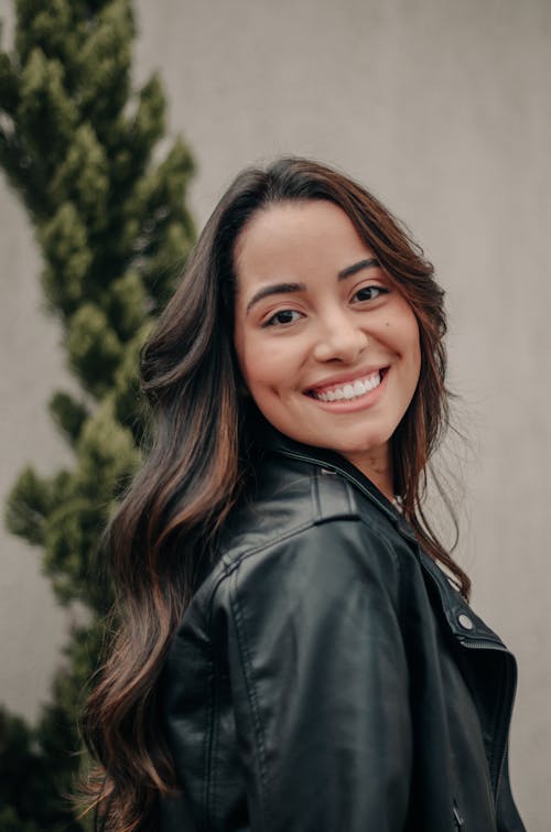 A woman in a leather jacket smiling