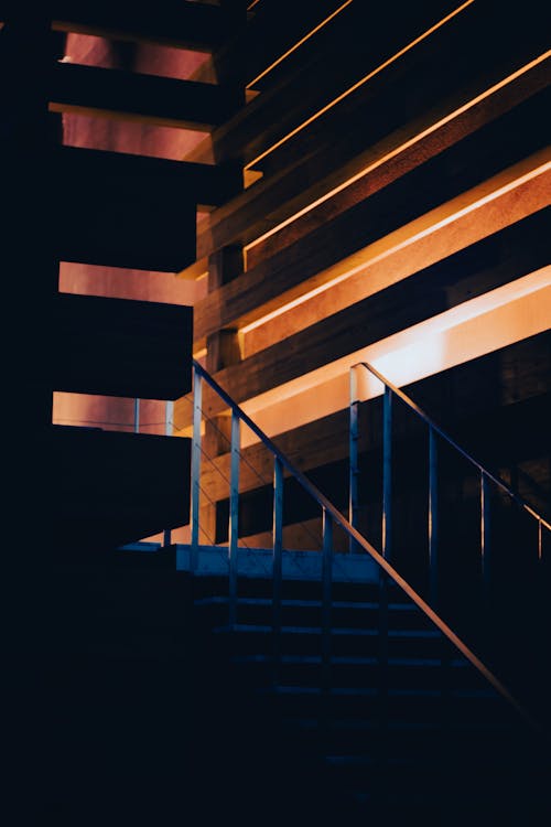 A stairway leading up to a building with a light shining on it