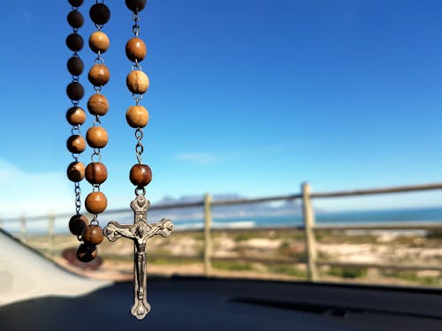 Selective Focus Photo of Brown and Silver Rosary