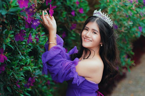 A young woman in purple dress posing for a photo