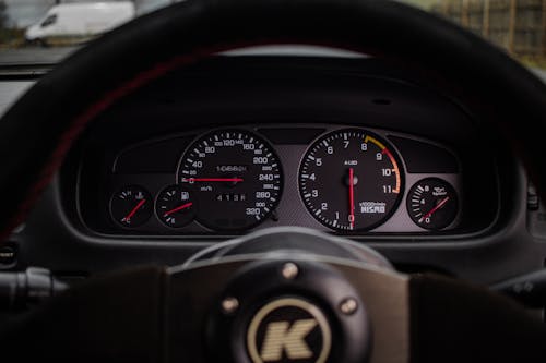 A dashboard with a speedometer and a speedometer