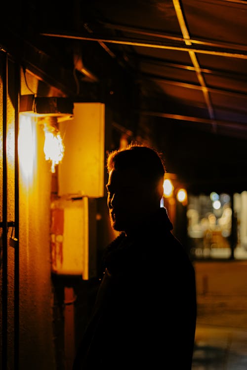 A man standing in the dark at night