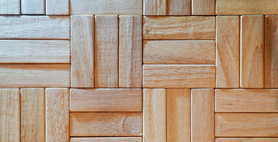 Close-up of wooden parquet flooring — the timber that a subterranean colony reaches once it is inside