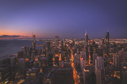 Beautiful aerial view of Chicago's illuminated cityscape at sunset.