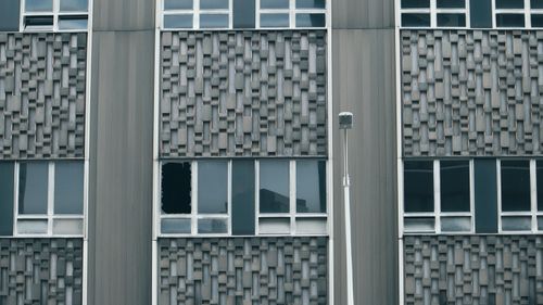 Free Close-up of a modern office building facade in Pittsburgh with a broken window. Stock Photo