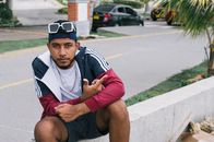 Casual urban portrait of a young man sitting on a street in Cartagena, Colombia.