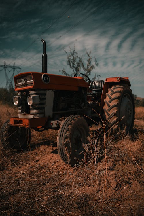 An old tractor sitting in a field