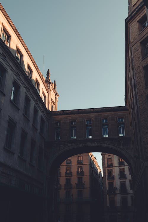 A bridge over a city street with buildings