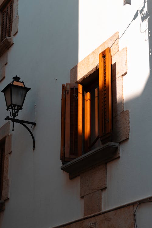 A street light and a window with shutters