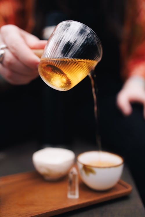 A person pouring coffee into a cup