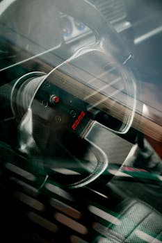 A detailed view of a sporty car's steering wheel and interior through a window in Southampton, England.