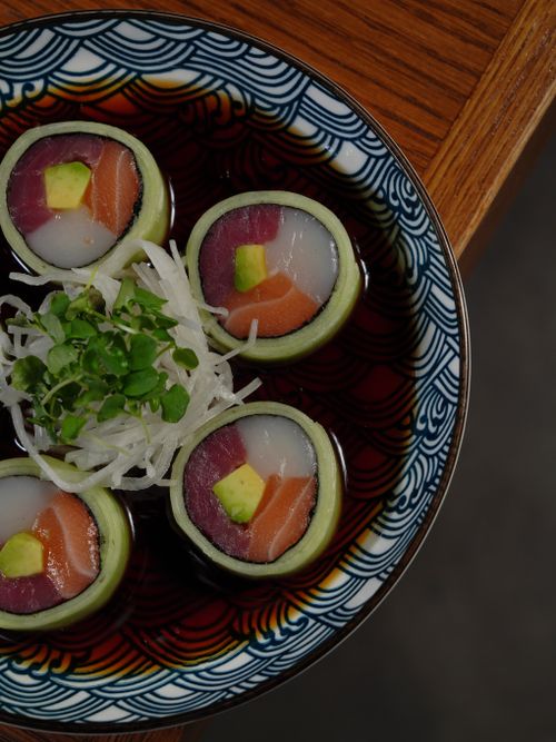 Free Top view of sushi rolls with avocado and fish in a decorative bowl. Perfect for gourmet food presentations and menus. Stock Photo