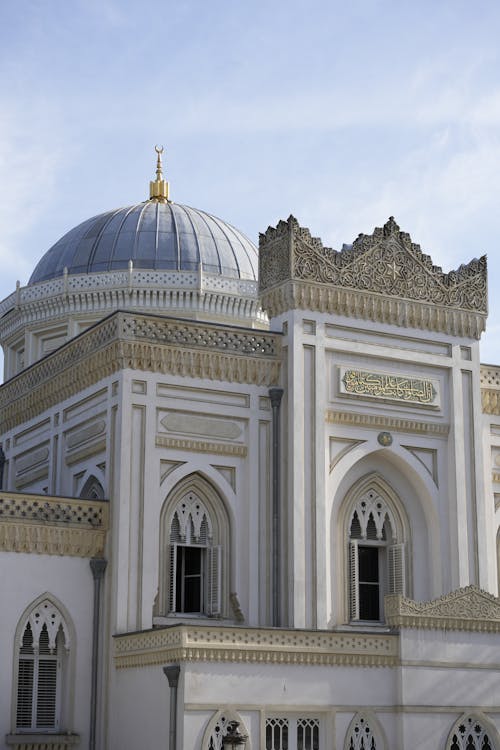 A white building with a dome and a clock