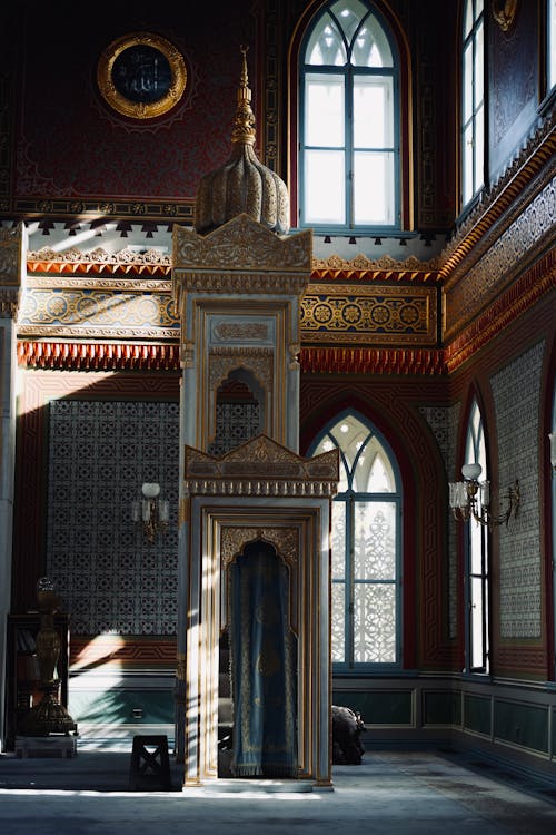 A large ornate room with a clock and a window