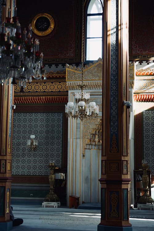 The interior of a building with ornate columns and chandeliers