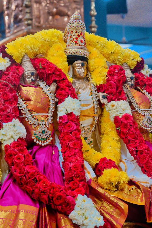 Three statues of lord krishna are on display