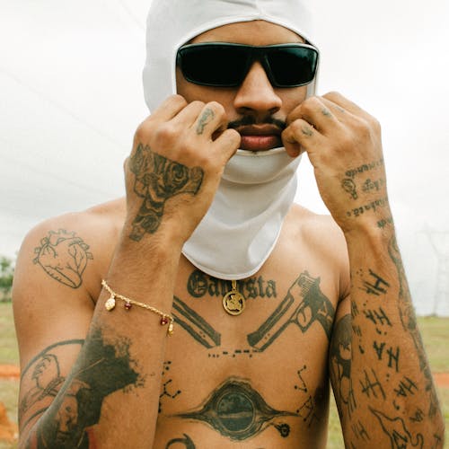 A man with tattoos on his face and neck